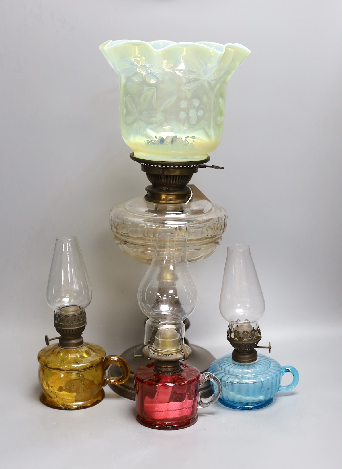 A Victorian oil lamp with vaseline glass shade and three small oil lamps, large oil lamp 49 cms high